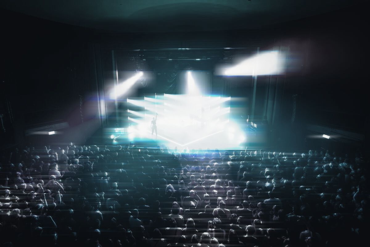 A full Vogue Theatre from above, facing a lit stage